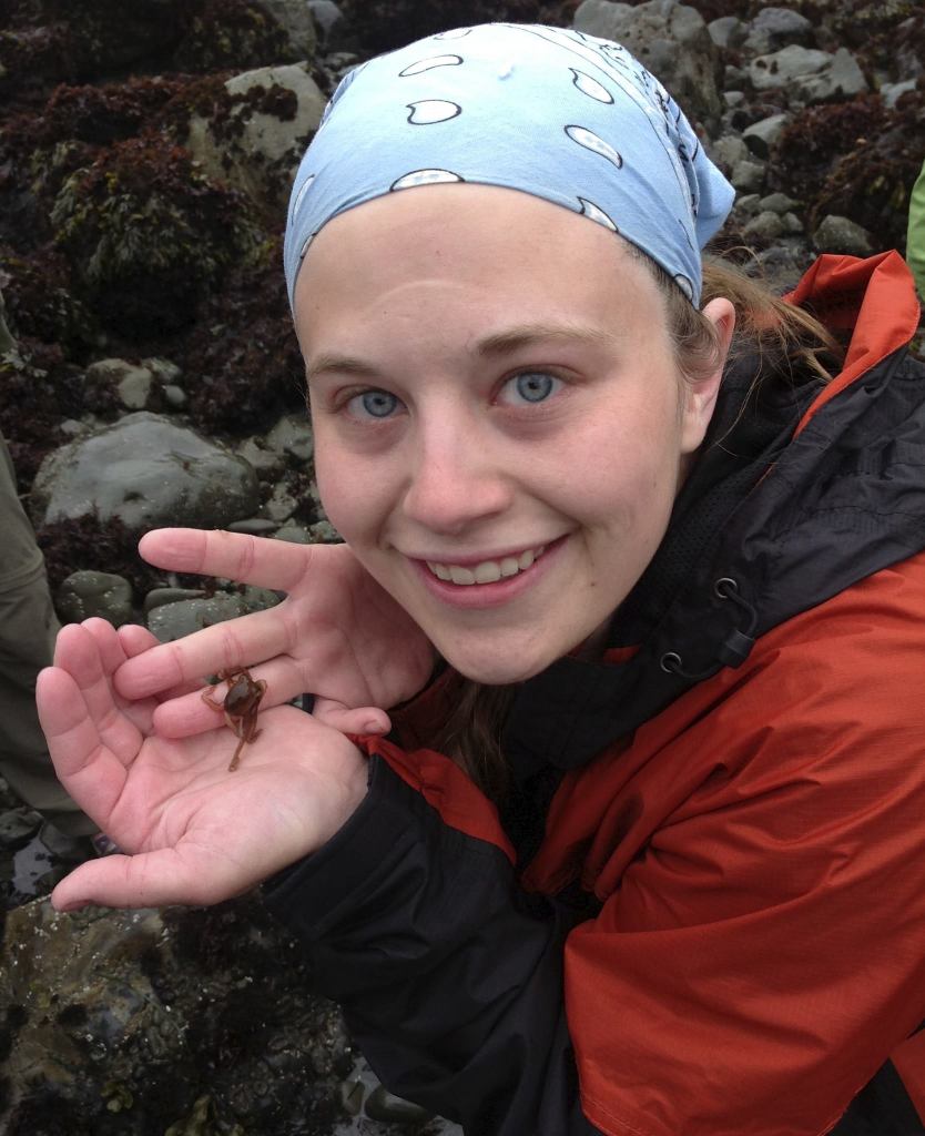 Courtney with a juvenile two-spotted octopus in the tidepools in the Pacific North West.
